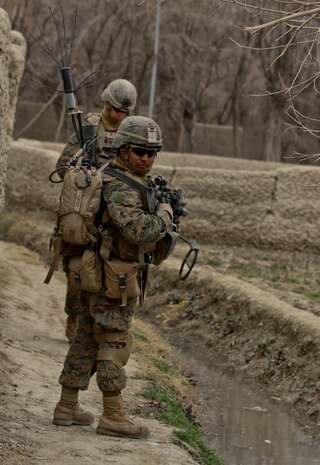 Corporal Manuel Ortiz, a team leader with 3rd Platoon, Lima Company, watches his rear security, while on patrol Feb. 26, 2012. Ortiz, currently deployed with 3rd Battalion, 7th Marine Regiment, used this deployment to train his Marines for future leadership roles. Ortiz mentored his Marines, drawing from his experience as a new Marine.