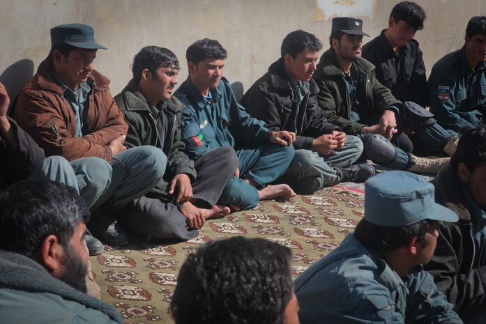 Afghan Uniformed Police officers watch and listen as members of Regimental Combat Team 5’s Police Advisory Team instruct refresher courses on vehicle check point procedures February 26, 2012. The Marines of the advisory team instruct the AUP and ALP on proper law enforcement procedures to prepare them to be self sufficient in security operations. (U.S. Marine Corps photo by Lance Cpl. Tyler Reiriz)
