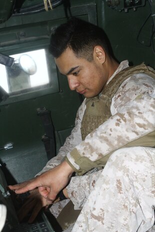 Lance Cpl. Nicholas A. Carillo, a gunner with 3rd Platoon, Tango Battery, 5th Battalion, 11th Marine Regiment, inputs data into the control panel of the High Mobility Artillery Rocket System during a dry-fire drill here, Feb. 26. The panel programs each GPS-guided rocket to fly to the correct grid coordinate. Each three-man launcher team drills every day to increase response time to support requests. The HIMARS allows the Marines to support fire missions within minutes and deliver precision fire within one meter of the target location.
