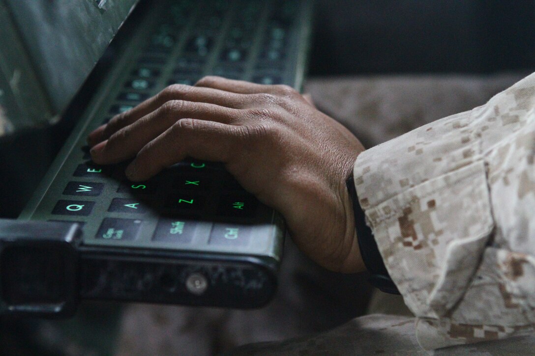 A Marine artillery gunner inputs data into the control panel of the High Mobility Artillery Rocket System during a dry-fire drill here, Feb. 26. The panel programs each GPS-guided rocket to fly to the correct grid coordinate. Each three-man launcher team drills every day to increase response time to support requests. The HIMARS allows the Marines to support fire missions within minutes and deliver precision fire within one meter of the target location.