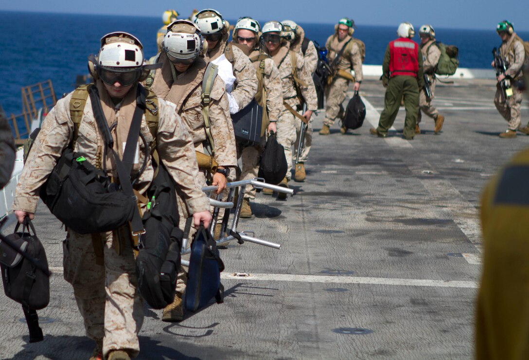 Marines serving with the 11th Marine Expeditionary Unit board the amphibious transport dock ship USS New Orleans here Feb. 26. The unit is deployed as part of the Makin Island Amphibious Ready Group, a U.S. Central Command theater reserve force. The group is providing support for maritime security operations and theater security cooperation efforts in the U.S. Navy’s 5th Fleet area of responsibility.