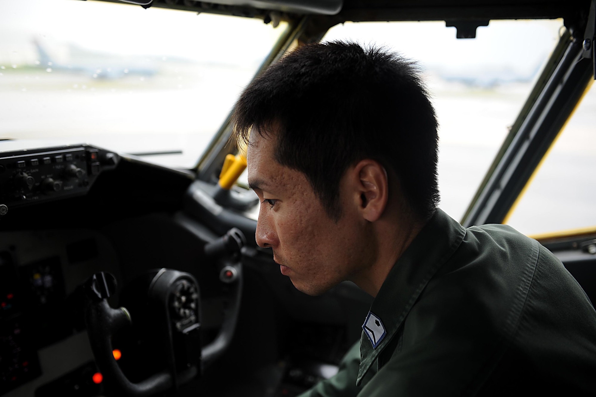 Japan Air Self-Defense Force Staff Sgt. Shuzo Masuda performs an operation check on the auto pilot function of a U.S. Air Force KC-135 Stratotanker refueling aircraft on Kadena Air Base, Feb. 24, 2012. Kadena recently took part in a NCO exchange program in which 10 NCOs from the JASDF came to work with their U.S. Air Force counterparts for a week. (U.S. Air Force photo by Airman 1st Class Brooke P. Beers/Released)