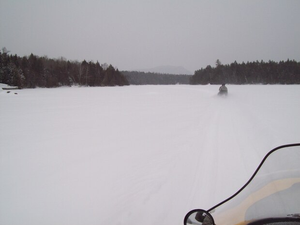 Members of the Moosehead Riders snowmobile club ride to the crash site, Piscataquis County, Maine. The aircraft crashed during a test mission on Jan. 24th, 1963 after encountering severe winter weather and losing its vertical stabilizer. Today, surviving relatives and concerned citizens hold an annual memorial service at the crash site. (courtesy photo)