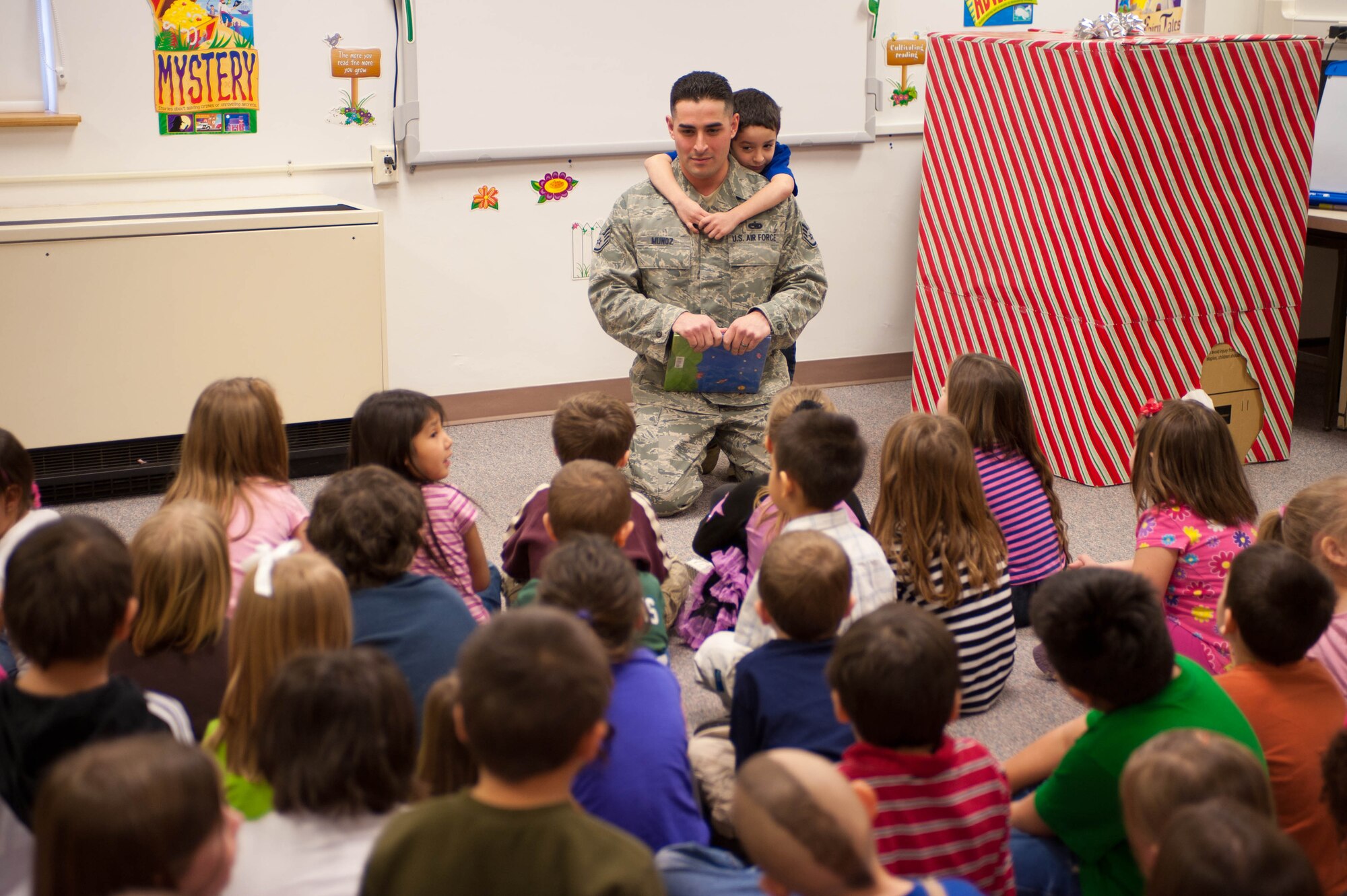 Staff Sgt. George Munoz, 28th Munitions Squadron weapon systems craftsman, answers questions about the military and his recent assignment to Kunsan Air Base, South Korea to kindergarten students at the Robbinsdale Elementary School library in Rapid City, S.D., Feb. 17, 2012. The students asked questions about military life and about Munoz’s experiences in the Air Force. (U.S. Air Force photo by Airman 1st Class Zachary Hada/Released)
