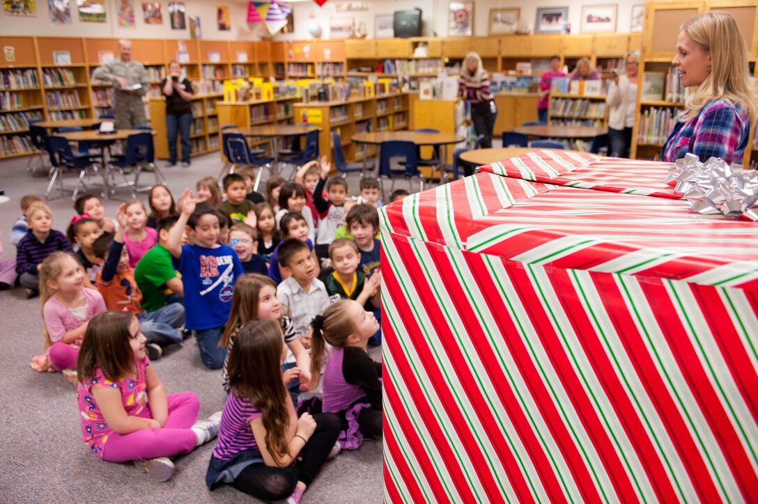 Tia Sparby, kindergarten teacher, brings kindergarten students to the library for a big surprise at the Robbinsdale Elementary School in Rapid City, S.D., Feb. 17, 2012. The surprise was Staff Sgt. George Munoz, 28th Munitions Squadron weapon systems craftsman, jumping out of a box to surprise his son. Until that morning, it had been a year since Munoz had seen his son, due to his year-long assignment to Kunsan Air Base, South Korea. (U.S. Air Force photo by Airman 1st Class Zachary Hada/Released)