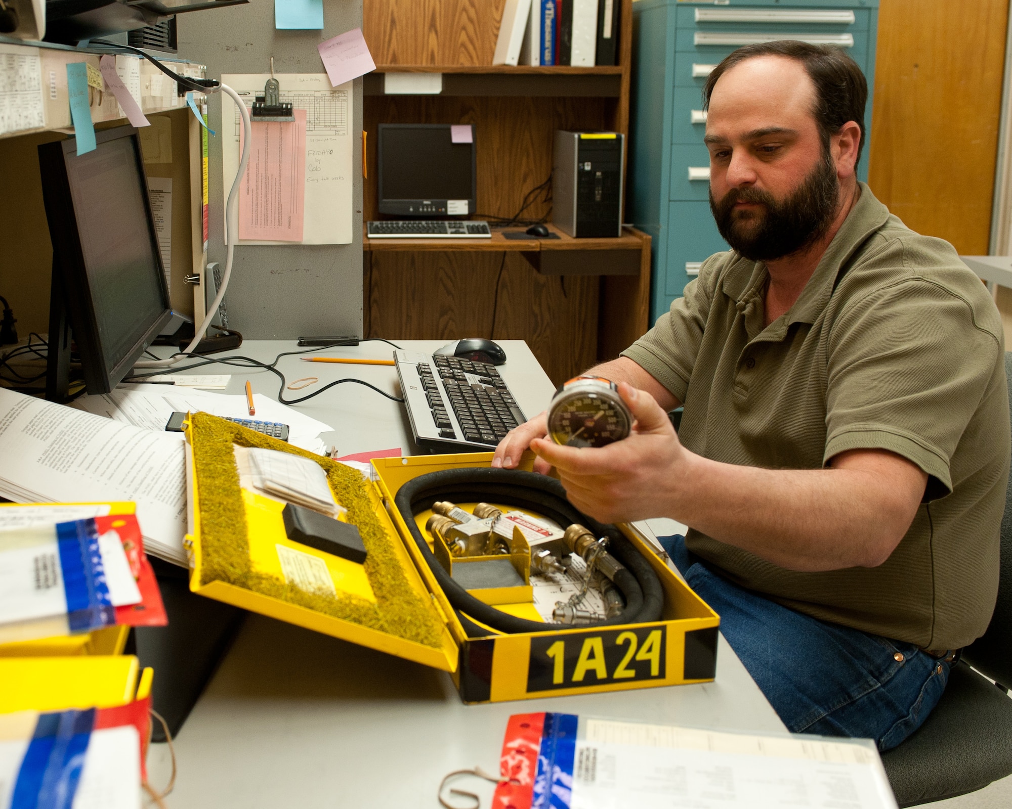 Gregory Larson, 28th Maintenance Squadron precision measurement equipment laboratory quality assurance inspector, verifies equipment and paperwork are accurate during quality assurance inspection at Ellsworth Air Force Base, S.D., Feb. 16, 2012. Larson is responsible for ensuring all equipment meets specific requirements prior to leaving PMEL. (U.S. Air Force photo by Airman Alystria Maurer/Released)