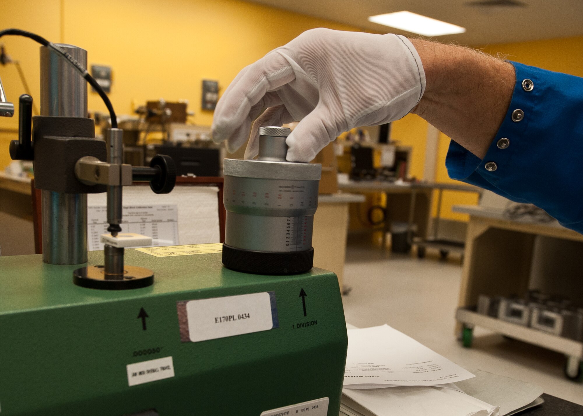 Scott Finch, 28th Maintenance Squadron precision measurement equipment laboratory lead technician, adjusts the controls  on a model 400B-5 calibrator on Ellsworth Air Force Base, S.D., Feb. 16, 2012. This machine helps to calibrate linear devices and dial indicators for pilots on the B-1B. (U.S. Air Force photo by Airman Alystria Maurer/Released)