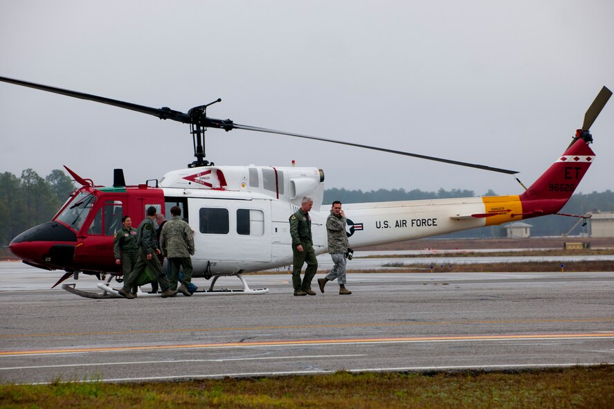 Col. Colin Miller, the 46th Test Wing commander, and others exit the flightline after their UH-1N Huey flight Feb. 27 to Duke Field, Fla.  The UH-1Ns belonging to the 40th Flight Test Squadron moved to Duke Field from Eglin Air Force Base, and merged under the 413th Flight Test Squadron.  The move is the first step to centralize all development, testing and evaluation of rotary wing aircraft in the Air Force.  (U.S. Air Force photo/Samuel King Jr.)