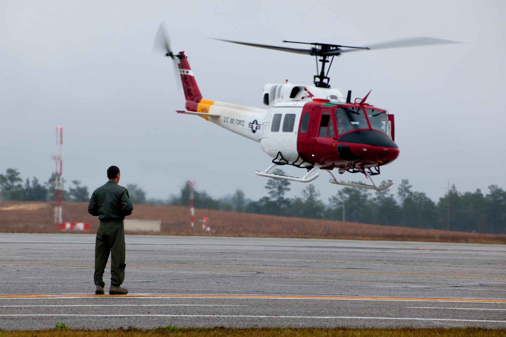 Lt. Col. Don Grove, the 413th Flight Test Squadron commander, greets his aircraft as it arrives at its new home Feb. 27 at Duke Field, Fla.  The 46th Test Wing UH-1N Huey flight left Eglin Air Force Base and the 40th Flight Test Squadron and are now a part of the 413th FTS.  The move is the first step to centralize all development, testing and evaluation of rotary wing aircraft in the Air Force.  (U.S. Air Force photo/Samuel King Jr.)