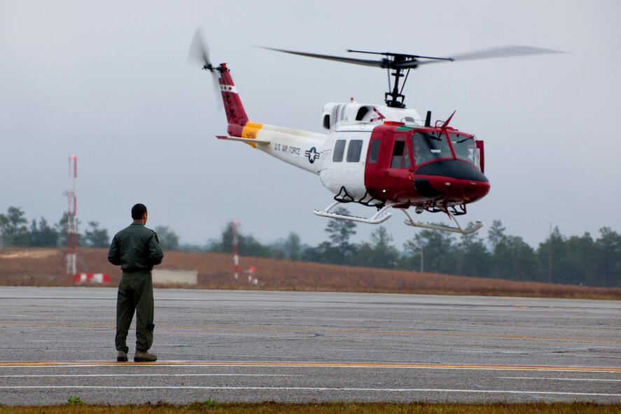 Lt. Col. Don Grove, the 413th Flight Test Squadron commander, greets his aircraft as it arrives at its new home Feb. 27 at Duke Field, Fla.  The 46th Test Wing UH-1N Huey flight left Eglin Air Force Base and the 40th Flight Test Squadron and are now a part of the 413th FTS.  The move is the first step to centralize all development, testing and evaluation of rotary wing aircraft in the Air Force.  (U.S. Air Force photo/Samuel King Jr.)