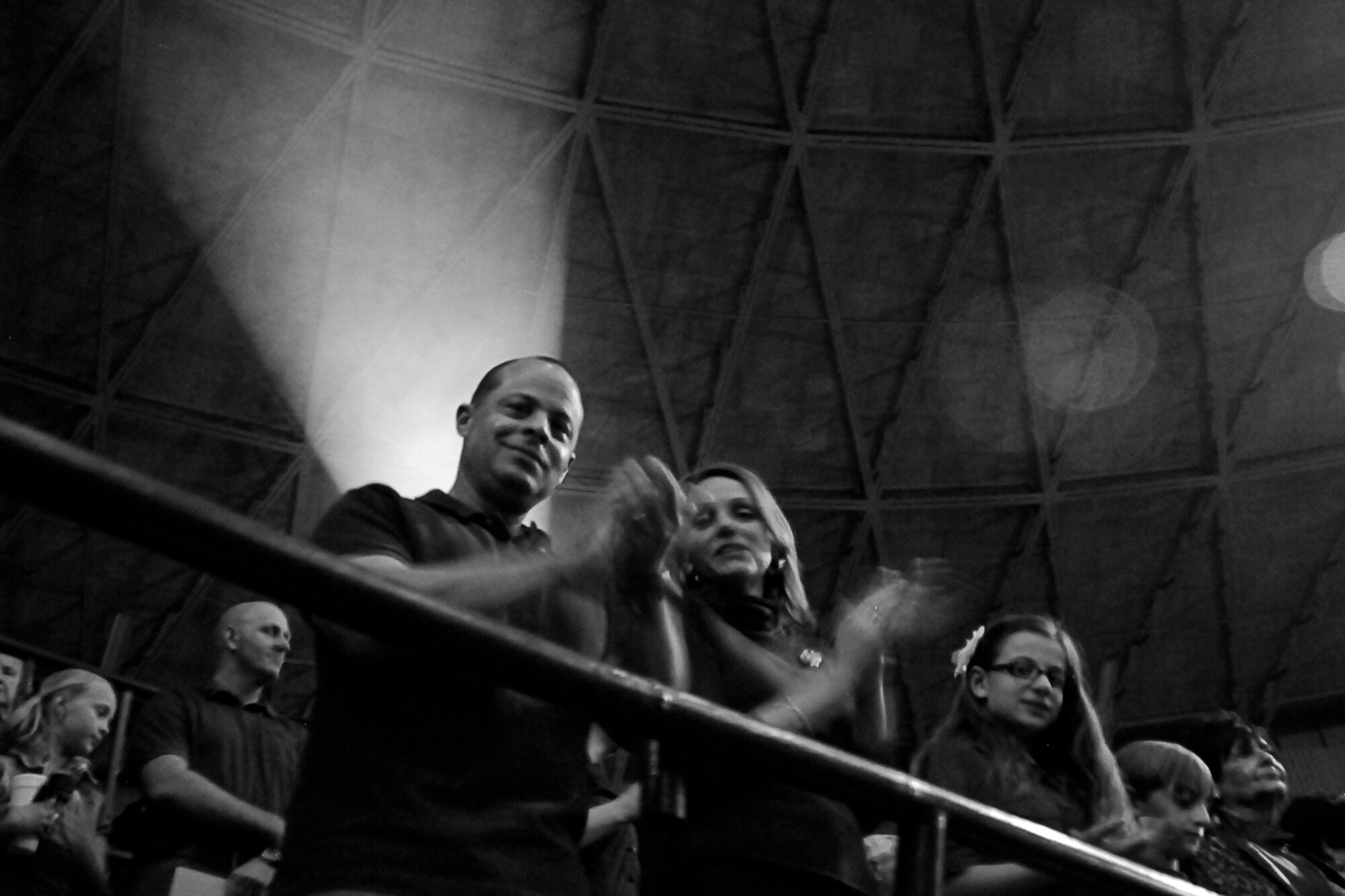 SAN ANGELO, Texas -- Col. Mark Damiano, 17th Training Wing Commander, Goodfellow Air Force Base, cheers alongside his family after the military appreciation night opening ceremony of the 80th Annual San Angelo Stock Show and Rodeo Feb. 22. Goodfellow's Patriotic Blue performed the national anthem and the Joint Service Color Guard presented the colors. (US Air Force photo/ Staff Sgt. Austin Knox)