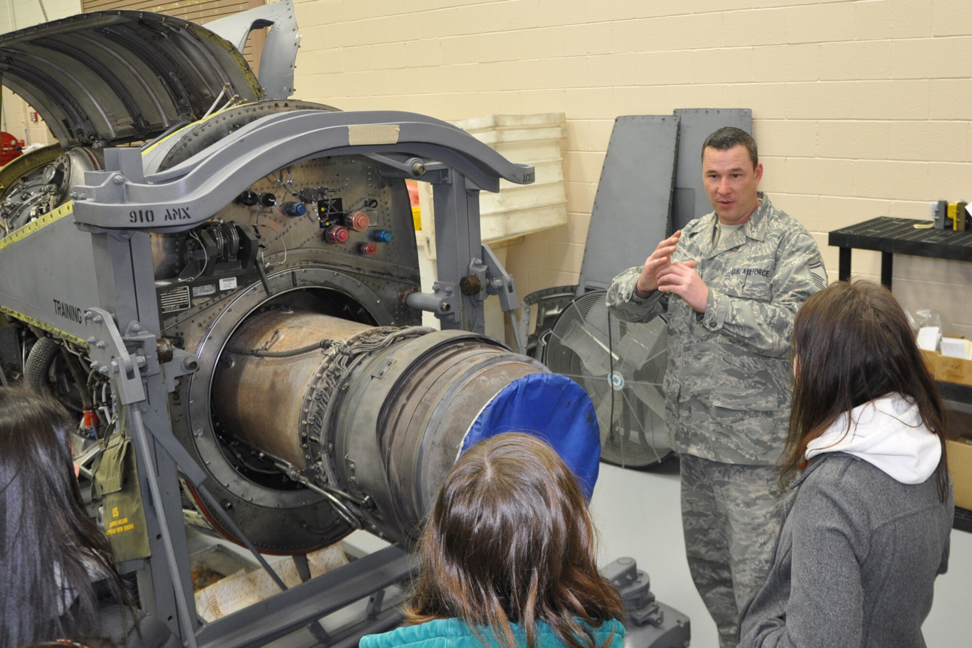 YOUNGSTOWN AIR RESERVE STATION, Ohio – Air Force Reserve Senior Master Sgt. Tom Seger, the Propulsion Flight Chief of the 910th Maintenance Squadron, explains how a C-130 engine is mounted to the aircraft wing to members from the nearby Kent State University chapter of the Women in Aviation (WIA) group here, Feb. 24, 2012. The students, who are pursuing various degrees in the field of aviation, walked through the 910th MXS Propulsion Shop as part of the group’s visit to YARS and the adjacent Youngstown-Warren Regional Airport. U.S. Air Force photo by Master Sgt. Bob Barko Jr.