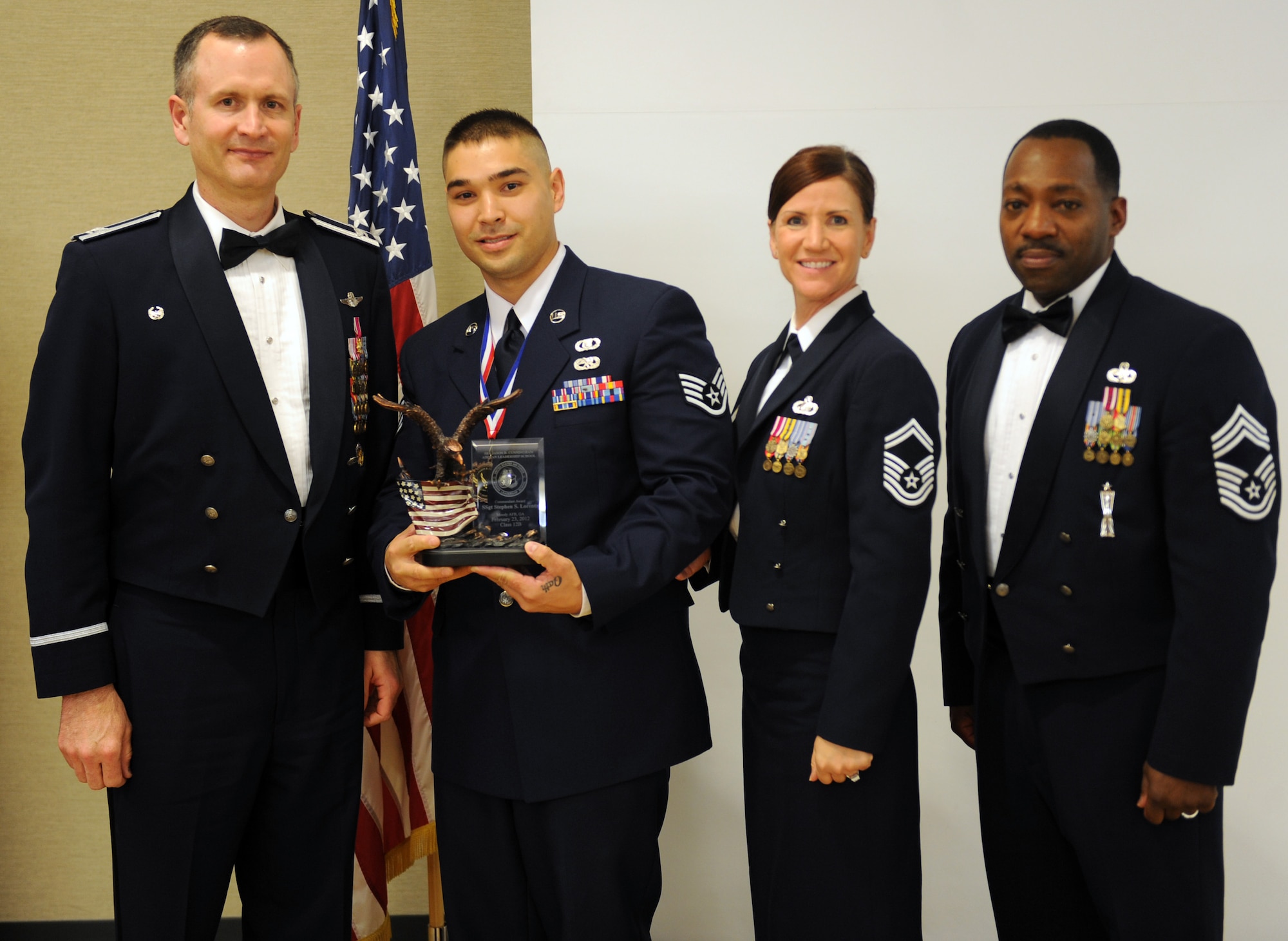 U.S. Air Force Staff Sgt. Stephen Lorentz, 347th Operations Support Squadron aircrew flight equipment journeyman, receives the Commandant award during an Airman Leadership School graduation Feb. 23, 2012, at Moody Air Force Base, Ga. Lorentz earned the award by demonstrating leadership and willingness to serve others. (U.S. Air Force photo by Airman 1st Class Douglas Ellis/Released)
