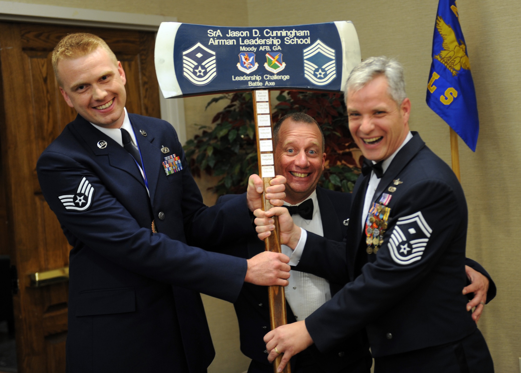 U.S. Air Force Staff Sgt. Collin Urbanowicz, 23d Equipment Maintenance Squadron crew chief, presents the Senior Airman Jason D. Cunningham Battle Axe to Chief Master Sgt. Tommy McDaniel, 820th Base Defense Group superintendant, and Senior Master Sgt. Jerrod Morse, 23d Aircraft Maintenance Squadron first sergeant, Feb. 23, 2012, at Moody Air Force Base, Ga. The battle axe is a trophy awarded to the winner of a sports game between the Top Three senior enlisted organization and ALS students. (U.S. Air Force photo by Airman 1st Class Douglas Ellis/Released)
