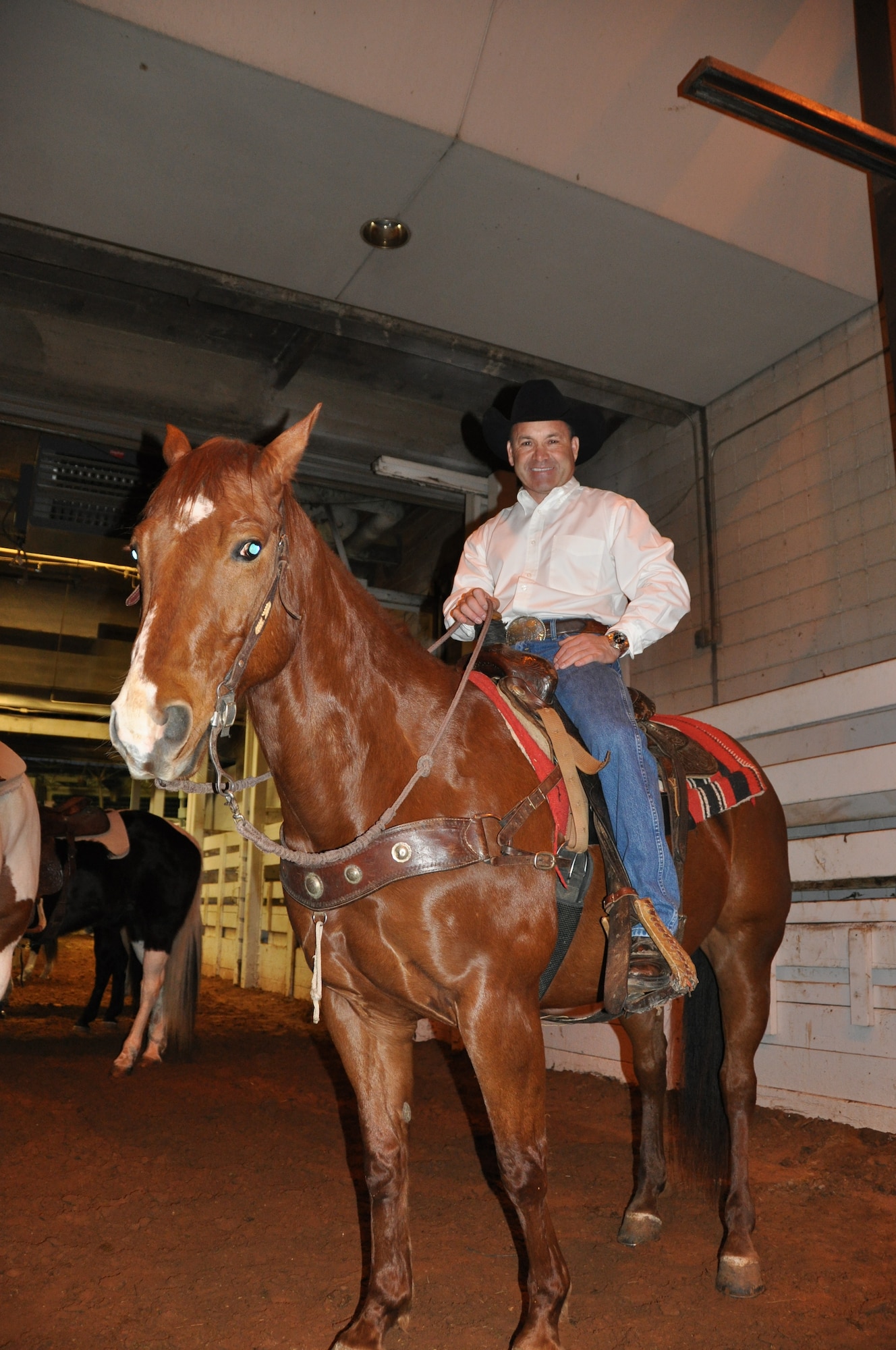 Col. Kurt Gallegos, 301st Operations Group commander, mounts up to participate in the opening processional ceremony for the 2012 Fort Worth Annual Stock Show and Rodeo. Gallegos has been an avid horse rider and champion rodeo rider for more than 30 years. The Fort Worth rodeo is one of the oldest and most widely respected in the country. (U.S. Air Force photo/TSgt Shawn David McCowan)
