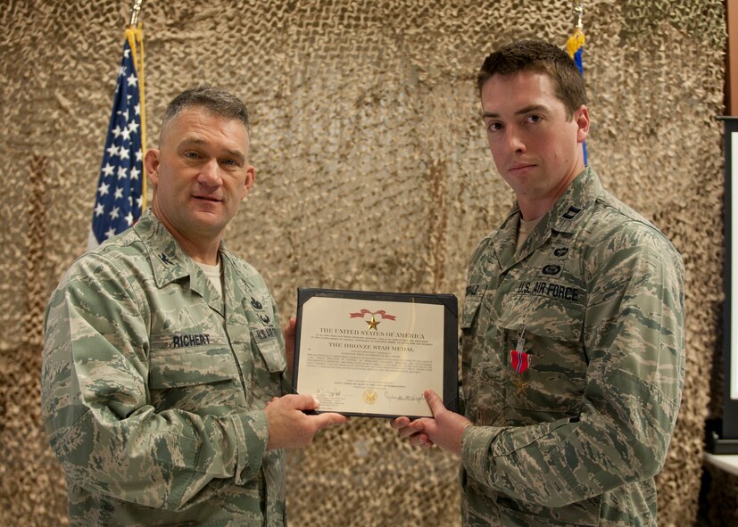 U.S. Air Force Col. Randall Richert, 820th Base Defense Group commander, presents the Bronze Star Medal to Capt. Jonathan McDonald, 820th Combat Operations Squadron influence operations and effects cell deputy chief, at Moody Air Force Base, Ga., Feb. 24, 2012. McDonald received the medal for his work while deployed to Kandahar Air Field, Afghanistan from September to December 2011. (U.S. Air Force photo by Senior Airman Eileen Meier/Released)
