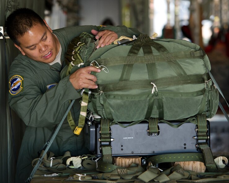 U.S. Air Force Master Sgt. Malcolm Mercado, 317th Airlift Group loadmaster, rigs a Joint Precision Airdrop System (JPADS) during training Feb. 22, 2012, at Dyess Air Force Base, Texas. JPADS is an airdrop system that uses Global Positioning Satellite, steerable parachutes and an onboard computer to steer loads to a designated point of impact on a drop zone – similar joint direct attack munitions. (U.S. Air Force photo by Staff Sgt. Jonathan Snyder/Released)