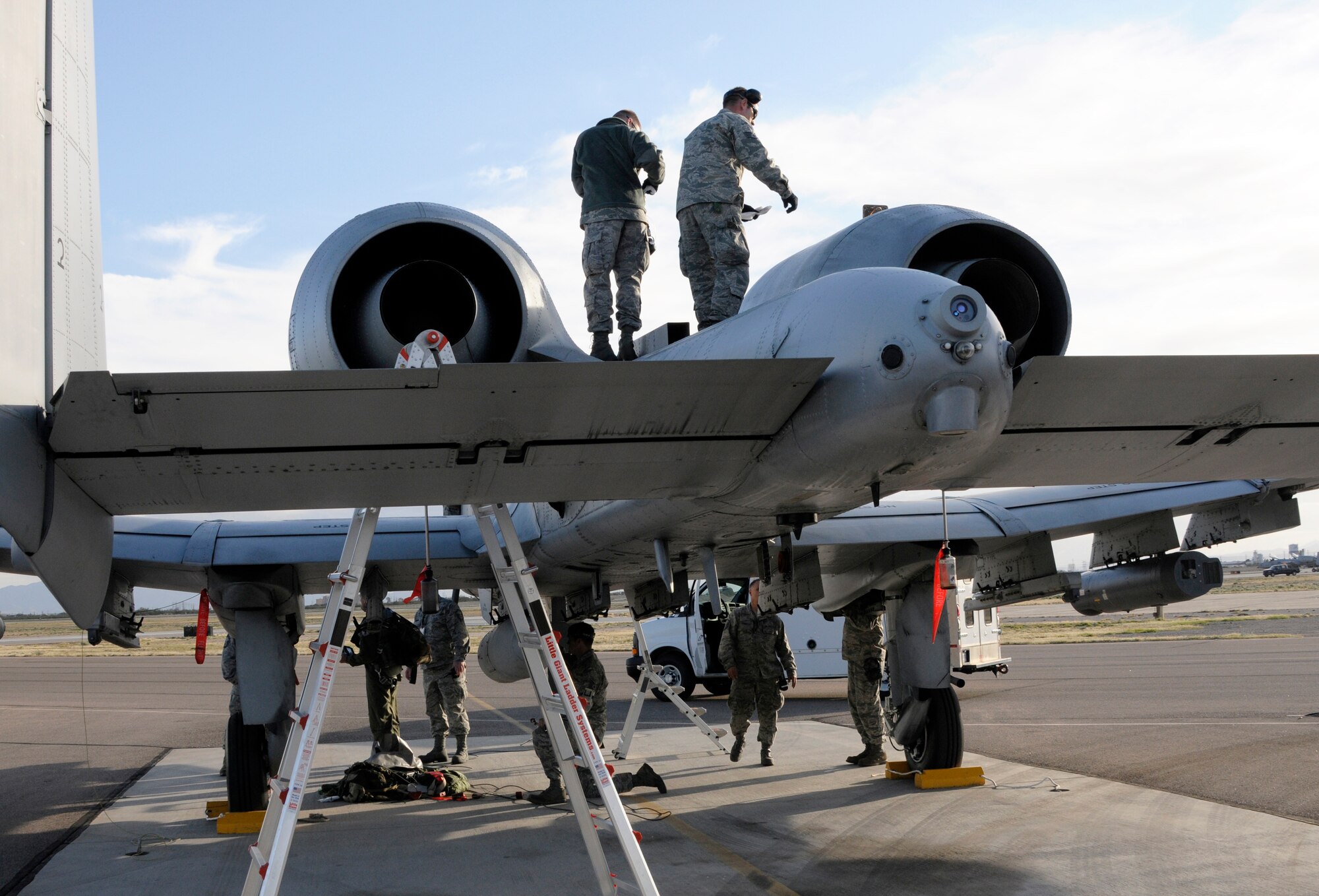 Airmen with the 188th Maintenance Group conduct a routine thru-flight inspection on an A-10C Thunderbolt II “Warthogs” with the 188th Fighter Wing during a deployment to Davis-Monthan Air Force Base, Ariz., Feb. 21 as part of Operation Snowbird. The objective of Operation Snowbird was to prepare the Flying Razorbacks for their deployment to Afghanistan this summer. (National Guard photo by Senior Master Sgt. Dennis Brambl/188th Fighter Wing Public Affairs)