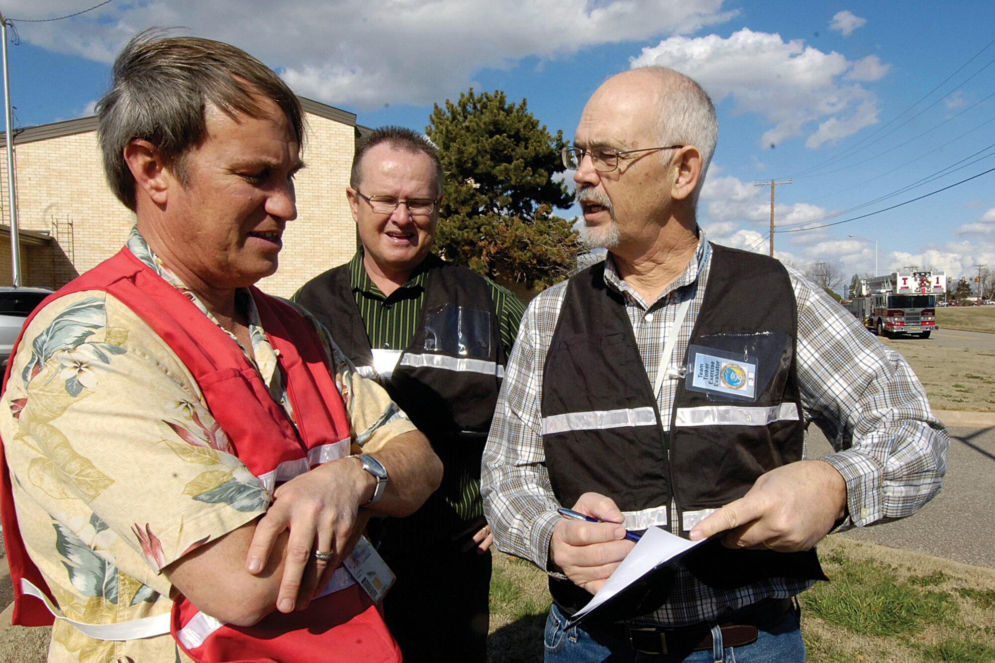 Planning base exercises keeps staff of the 72nd Air Base Wing Plans and Programs Office busy laying out scenarios from weather disasters, hazardous chemical emergencies and attacks by foreign and domestic enemies, all to keep Tinker personnel trained for anything. During the early phase of a recent Emergency Response to a Natural Disaster exercise Feb. 15, exercise planner Paul Logan, exercise evaluation team chief Jim Wagoner and exercise planner Jonny Conover, from left (all 72nd Plans and Programs Office), discuss the unfolding scenario. (Air Force photo by Margo Wright)