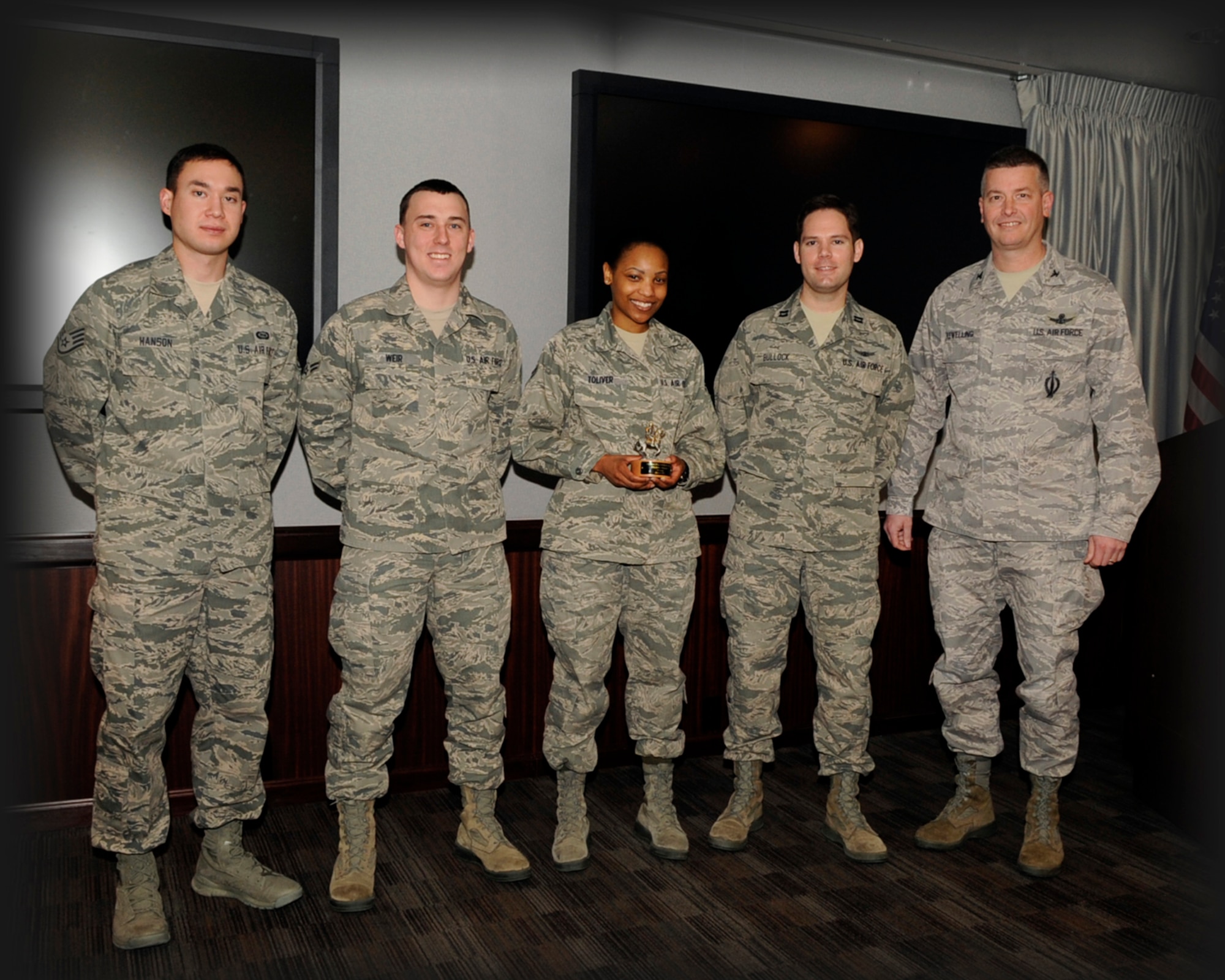 Col. Jeffrey Flewelling (right), 21st Space Wing vice commander, presented the January Gold Knight Award Feb. 22 to the 21st Operations Support Squadron Phobos-Grunt team. (U.S. Air Force photo/Rob Bussard)