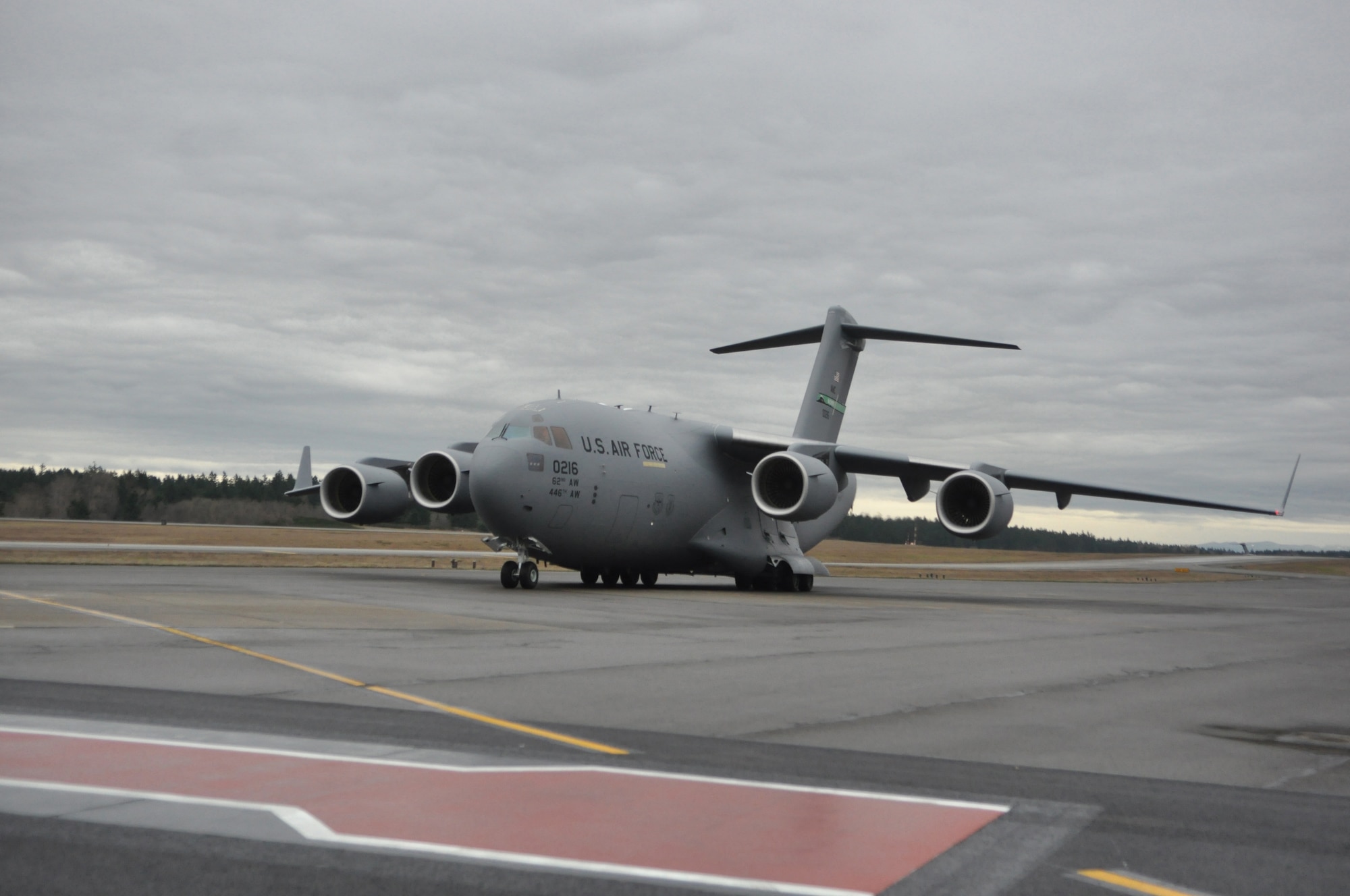 McChord Field's newest C-17 Globemaster III aircraft taxis down a runway Feb. 24, 2012, at Joint Base Lewis-McChord, Wash. The C-17 was delivered by Gen. Raymond E. Johns, Jr.,  Air Mobility Command commander. (U.S. Air Force photo/Staff Sgt. Frances Kriss) 
