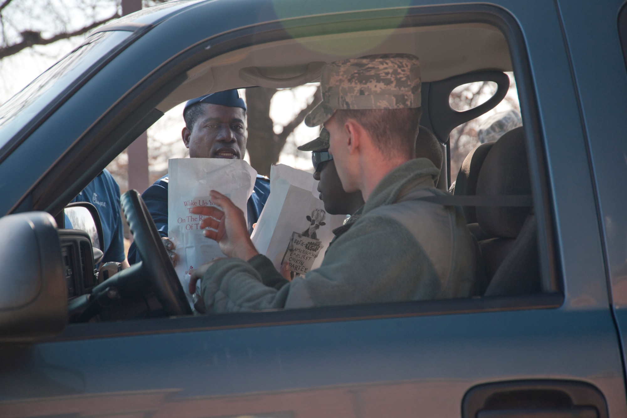 Chaplain (Capt.) Denis Geue, 11th Wing chaplain, distributes Chick-fil-a meals 
to a truck full of hungry Airmen from the 11th Civil Engineering Squadron 
during the Chick-fil-a giveaway at Chapel 1 on Feb. 17. The 11th Wing Chapel 
and Chick-fil-A worked together on the event.  Together, they distributed 500 
meals to show appreciation for service members and their dependents at Joint 
Base Andrews.  The underlying purpose for the show of love was to lead into 
the commencement of lent on Ash Wednesday.  (U.S. Air Force Photo/Senior 
Airman Amber Russell)
