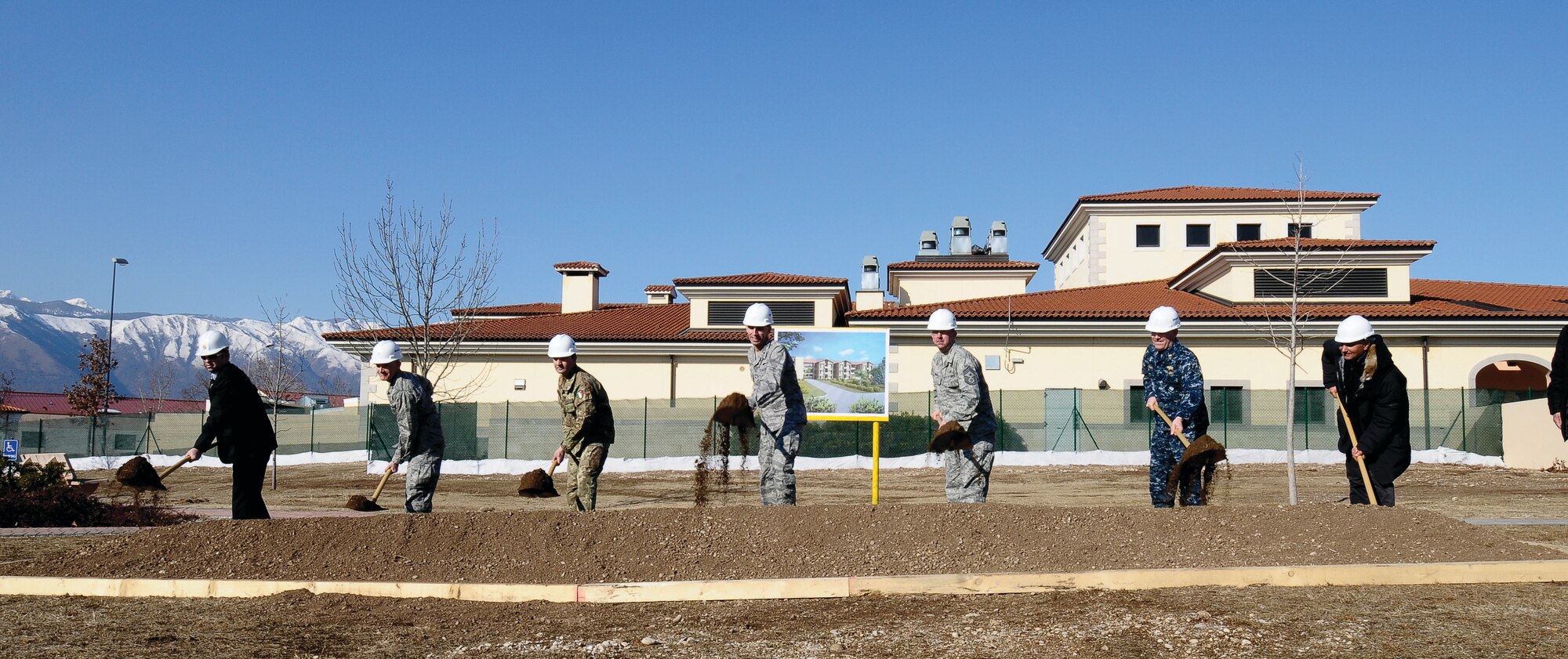Brig. Gen. Scott Zobrist, 31st Fighter Wing commander, exalts the virtues of a new, energy-efficient dormitory being built Feb. 23 at Aviano Air Base, Italy. Wing leadership plans to move all U.S. Air Force assets out of Area 2, returning it to the Italian air force. The new dormitory will remove the plan’s primary roadblock. The facility also has a Leadership in Energy and Environmental Design silver-certified rating for efficiency, significantly reducing the Air Force’s carbon footprint and utility bill. (U.S. Air Force photo/Senior Airman Katherine Windish)