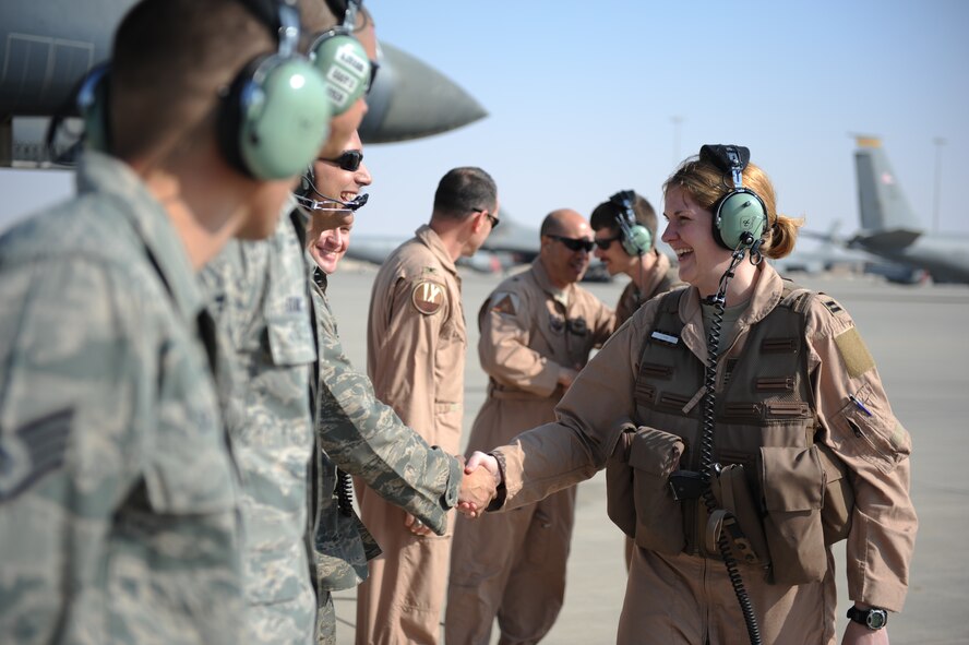 U.S. Air Force Capt. Laura Hunstock, 9th Expeditionary Bomb Squadron weapon systems officer and native of Bossier City, La., shakes hands with her crew chiefs before the 10,000th combat mission Feb. 26, 2012. The B-1, or “Bone” as it is affectionately known, performed its first combat mission in December 1998 during Operation Desert Fox. Several upgrades have been made to the B-1 over the last 30 years in order to make it a highly versatile, multi-mission weapon system. (U.S. Air Force photo/Staff Sgt. Nathanael Callon/Released)