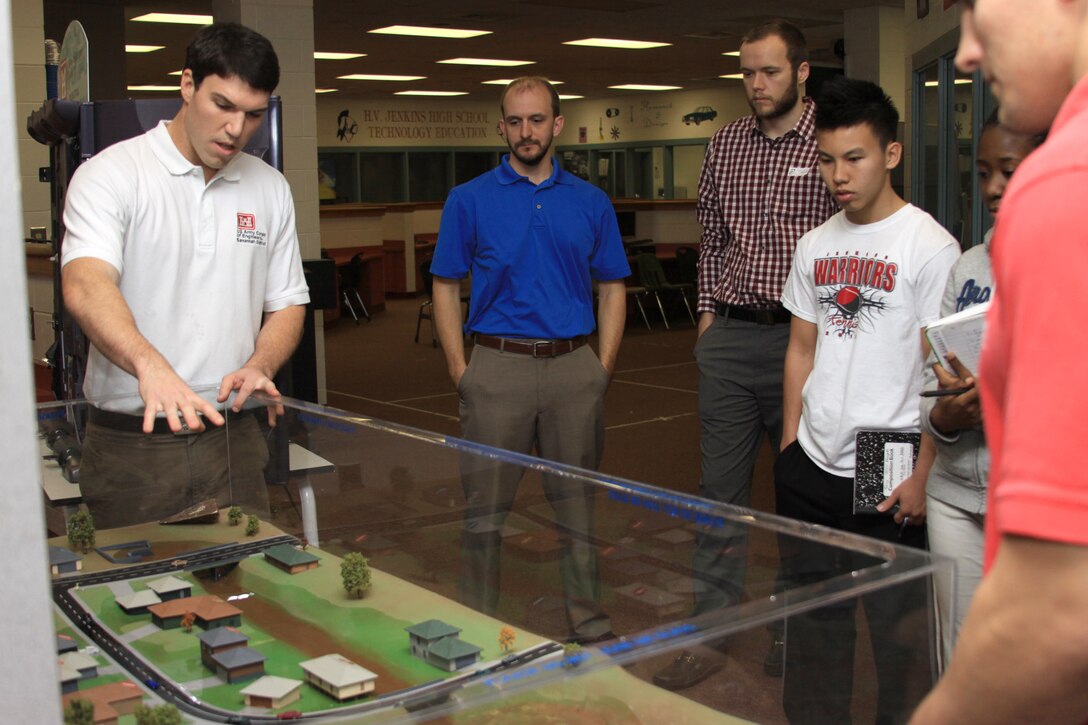 SAVANNAH, Ga. — Jason Lavecchia (left), a civil engineer with the U.S. Army Corps of Engineers Savannah District explains flood damage prevention techniques with an interactive flood plain model to students here, Feb. 23, 2012.