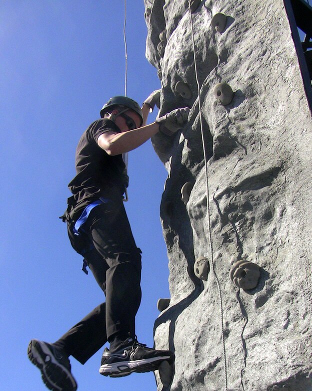 VALENCIA, Calif. — A future service member climbs a rock wall set up as part of the grand opening of an Armed Forces Career Center at the Westfield Valencia Town Center mall here, Feb. 24, 2012. The U.S. Army Corps of Engineers Los Angeles District manages the lease of the 5,147 square foot facility, one of more than 250 in Southern California, Arizona and Nevada.