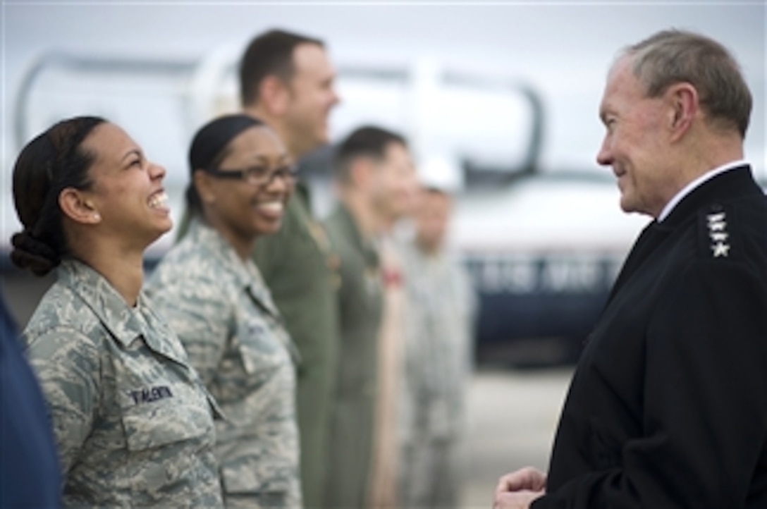 A U.S. Air Force airman (left) talks with Chairman of the Joint Chiefs of Staff Gen. Martin E. Dempsey during a town hall meeting at Naval Air Station Pensacola, Fla., on Feb. 22, 2012.  