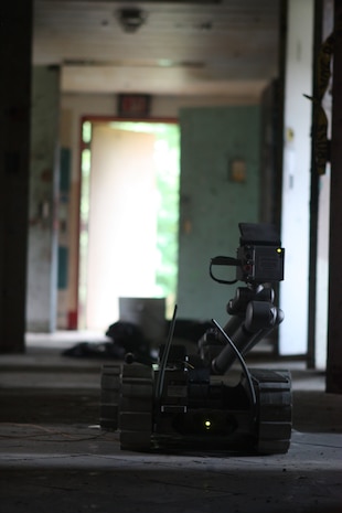 Lorton, VA - Explosive Ordinance Technicians with Initial Response Force "A," React Company, Chemical Biological Incident Response Force, maneuvers a PackBot Mark II towards an improvised explosive device during their certification exercise 14 June.