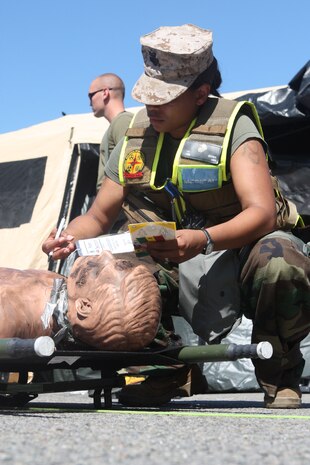RANDALL’S ISLAND, N.Y. – Hospitalman first class Latanya Brown, triages victims after they pass through the decontamination line during training with the New York City Fire Department’s Special Operations Command fire fighters. Marines and sailors of CBIRF have trained with FDNY since July of 2000. Deputy Chief Raymond M. Downey, of FDNY’s SOC, helped CBIRF develop their technical rescue program before he later died on 9/11 in the World Trade Center towers. (released)