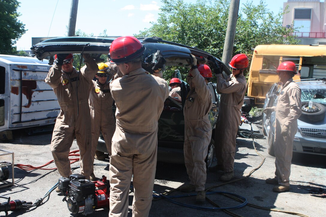 RANDALL’S ISLAND, N.Y. – Marines with Initial Response Force B, Chemical Biological Incident Response Force remove the roof of a van during cross training in vehicle extrication from New York City Fire Department’s Special Operations Command fire fighters. Marines and sailors of CBIRF went through a week-long training evolution to involve vehicle extrication, rope rescue, and breaching and breaking through concrete. CBIRF’s Marines and sailors have trained with FDNY since July of 2000. Deputy Chief Raymond M. Downey, of FDNY’s SOC, helped CBIRF develop their technical rescue program before he later died on 9/11 in the World Trade Center towers. (released)