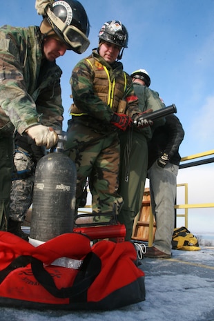 Sgt. Nick Janey and Sgt. Dan Bronza, technical rescue Marines with Chemical Biological Incident Response Force’s Technical Rescue Platoon prepare the "rope gun" to connect the two towers for the high-angle rope rescue during the joint 72-hour technical rescue training operation with the 911th U.S. Army Technical Rescue Engineer Company at the Downey Responder Training Facility. The two units take the opportunity to train together to build a good working relationship and familiarity of each other’s capabilities and limitations because both units cover the National Capitol Region, they would have to work together if there were ever a disaster.