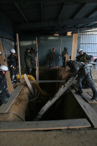 Soldiers from 911th U.S. Army Technical Rescue Engineer Company and Marines from Chemical Biological Incident Response Force's Technical Rescue Platoon work to stabilize a trench before attempting to enter and extract two “victims” after a simulated collapse during CBIRF's annual 72-hour technical rescue training operation at the Downey Responder Training Facility. This joint 72-hour technical rescue training operation at DRTF allowed the two units take the opportunity to train together to build a good working relationship and familiarity of each other’s capabilities and limitations. Since both units cover the National Capitol Region, in the event of a disaster, both units would work side by side.