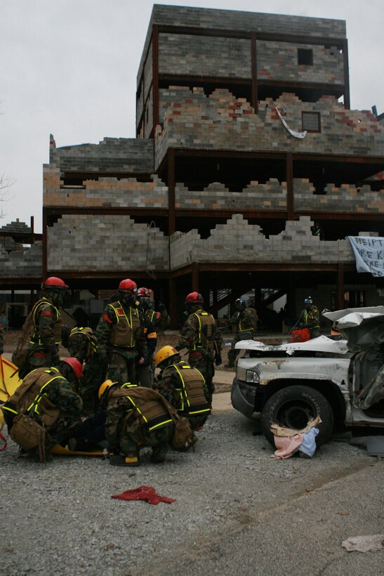MUSCATATUCK URBAN TRAINING CENTER, Ind. - Marines and sailors from Initial Response Forces B, Chemical Biological Incident Response Force, search for and extract 'casualties' during a 12-hour training exercise at the training operation Vibrant Response 1.1. The Marines and sailors of CBIRF drove from their base, Naval Support Facility Indian Head, in Maryland to Indiana and transitioned straight into a 24-hour training operation.