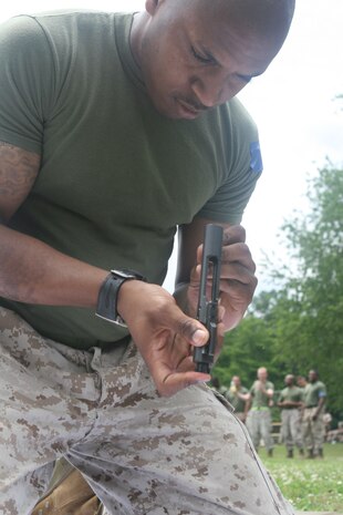 NAVAL SUPPORT FACILITY INDIAN HEAD, Md – Sergeant Brandon Murphy, Decontamination Platoon Safety NCO, Initial Response Force B, React Company, Chemical Biological Incident Response Force reassembles an M16 – A4 service rifle in the rifle relay race during CBIRF’s battalion field meet 24 May. Headquarters and Support Company, IRF A and IFR B all competed against one another in several events to strengthen unit cohesion and win bragging rights after the safety brief before the Memorial Day weekend.