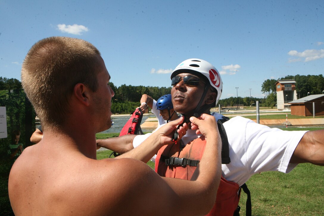 A Marine with 1st Battalion, 10th Marine Regiment, 2nd Marine Division, has his protective equipment inspected to insure his safety while whitewater rafting, Sept. 29. The Marines with 1/10 participated in different extreme and outdoor sports as part of Operation Adrenaline Rush, a program geared towards post-deployment stress management.