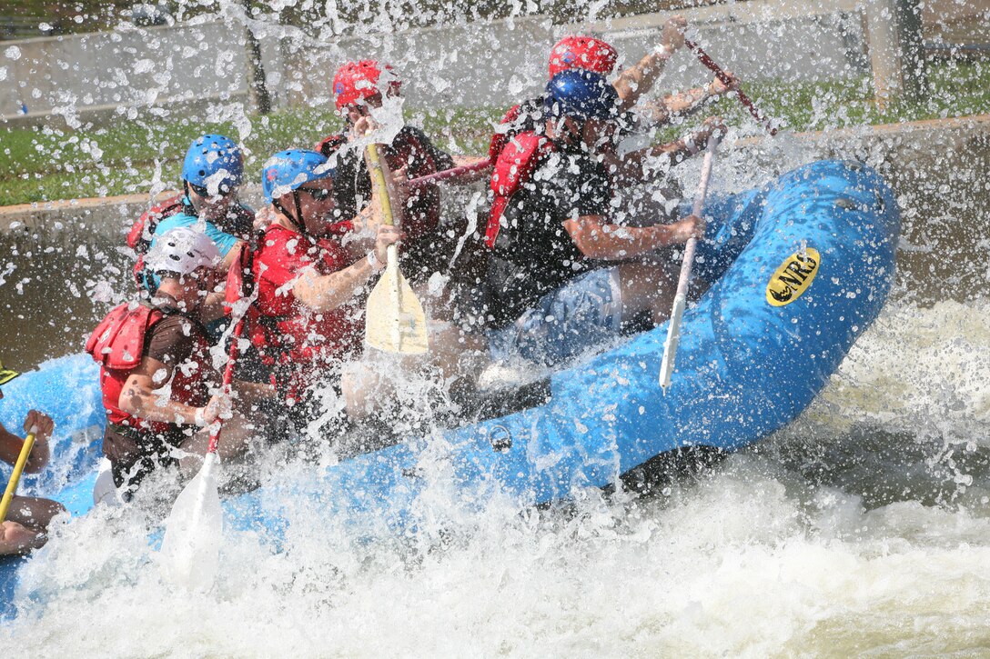 Marines with 1st Battalion, 10th Marine Regiment, 2nd Marine Division, tackle a few waves while whitewater rafting at the U.S. National Whitewater Center in Charlotte, N.C., Sept. 29. The Marines with 1/10 participated in different extreme and outdoor sports as part of Operation Adrenaline Rush, a program geared towards post-deployment stress management.