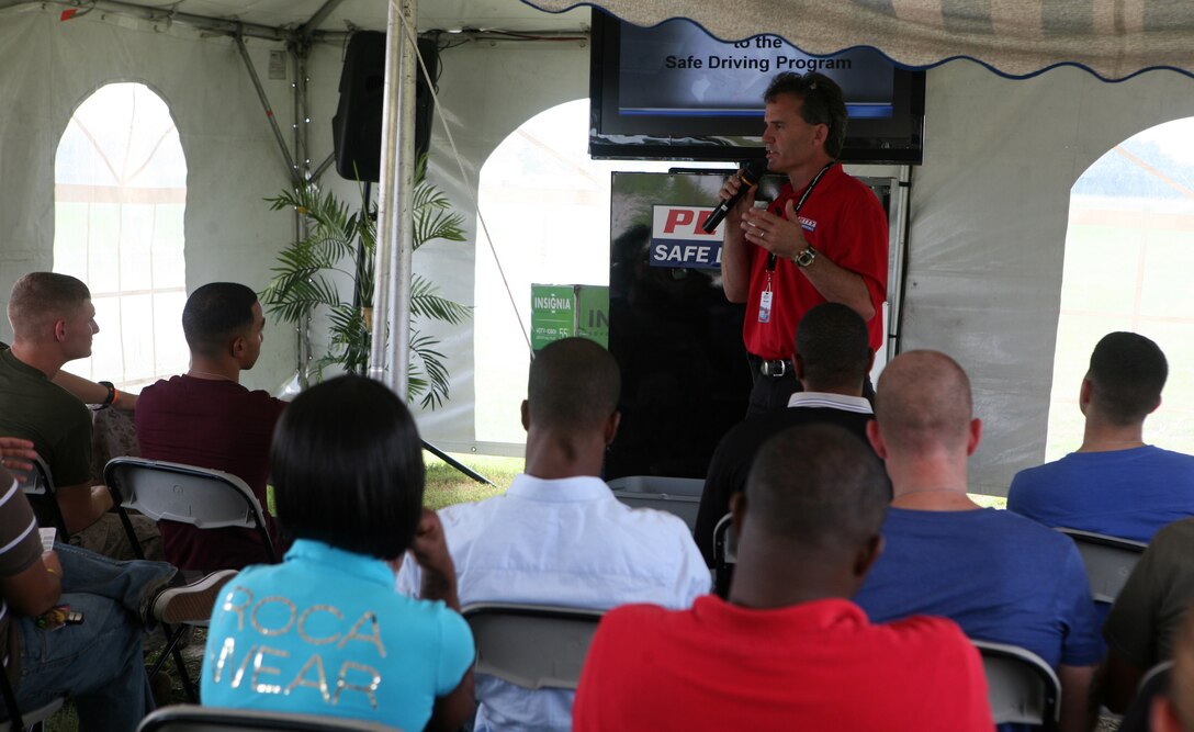 Rick C. Fedrizzi, the President Chief Operator of the Richard Petty Driver Experience, talks to Marines and sailors from 2nd Marine Logistics Group about the dangers of distractive driving during the Richard Petty Driver Experience at Marine Corps Auxiliary Landing Field Bogue, N.C., Sept. 21, 2011.  The course focused on braking, reaction times, tailgating and loss of control.  (Photo by Sgt. Rachael K. A. Moore)