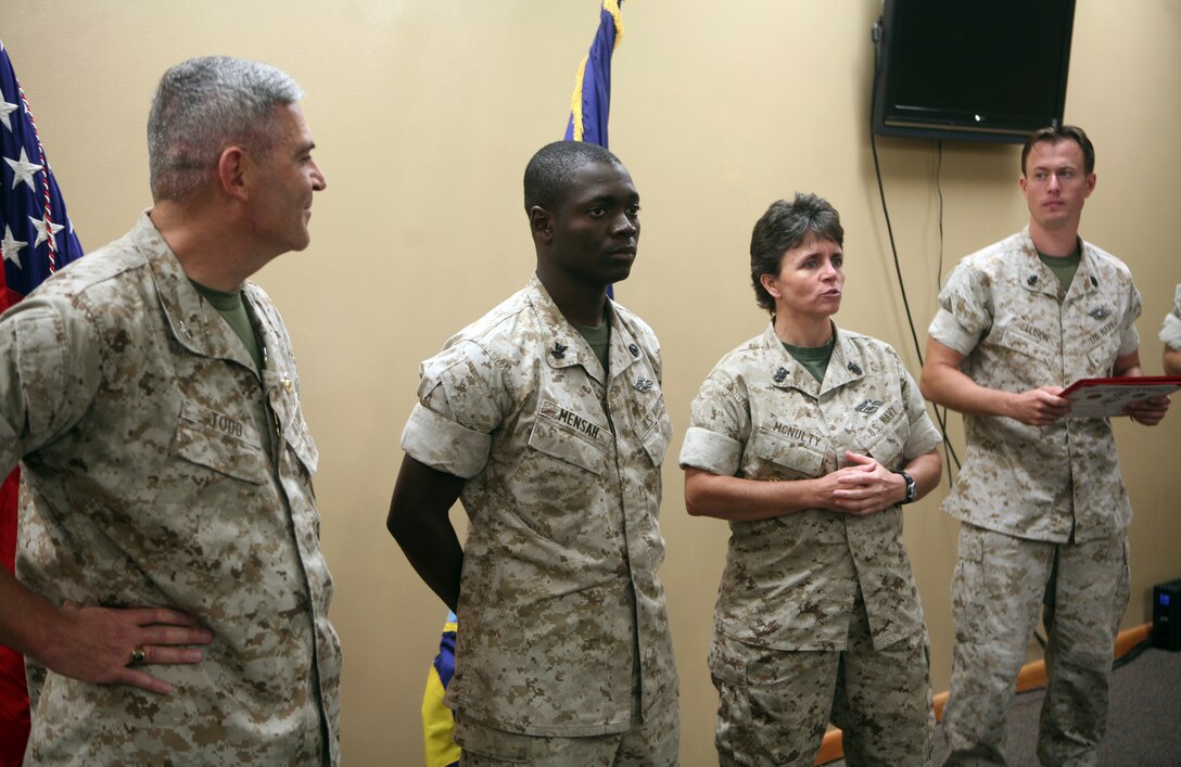 Petty Officer 2nd Class Henry Mensah, a religious program specialist with 2nd Marine Logistics Group, stands at parade rest as Master Chief Kelly Mcnulty, command master chief for 2nd MLG, speaks on his behalf during an award ceremony at the 2nd MLG Chaplain Center aboard Camp Lejeune, N.C., September 19, 2011. Mensah received the Junior Sailor of the Quarter Award for his outstanding work and determination. (U.S. Marine Corps photo by Pfc. Franklin E. Mercado)