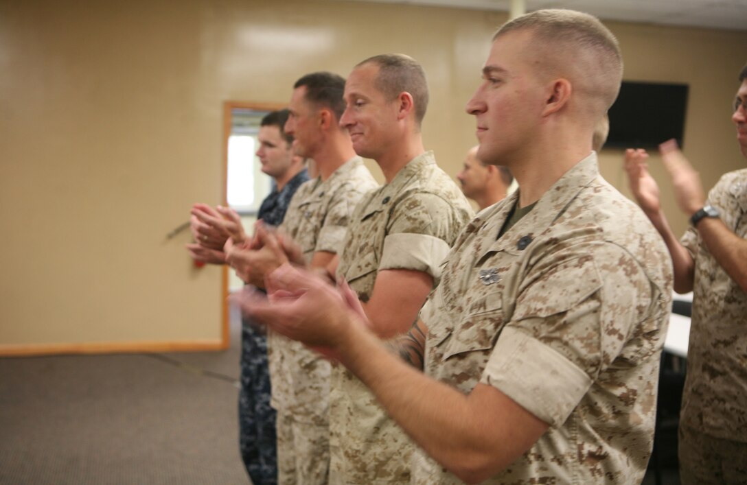 Fellow sailors applaud Petty Officer 2nd Class Henry Mensah, a religious program specialist with 2nd Marine Logistics Group, for receiving the Junior Sailor of the Quarter Award during a ceremony at the 2nd MLG Chaplain Center aboard Camp Lejeune, N.C., September 19, 2011. The award recognizes junior sailors for hard work and dedication to their daily duties. (U.S. Marine Corps photo by Pfc. Franklin E. Mercado)