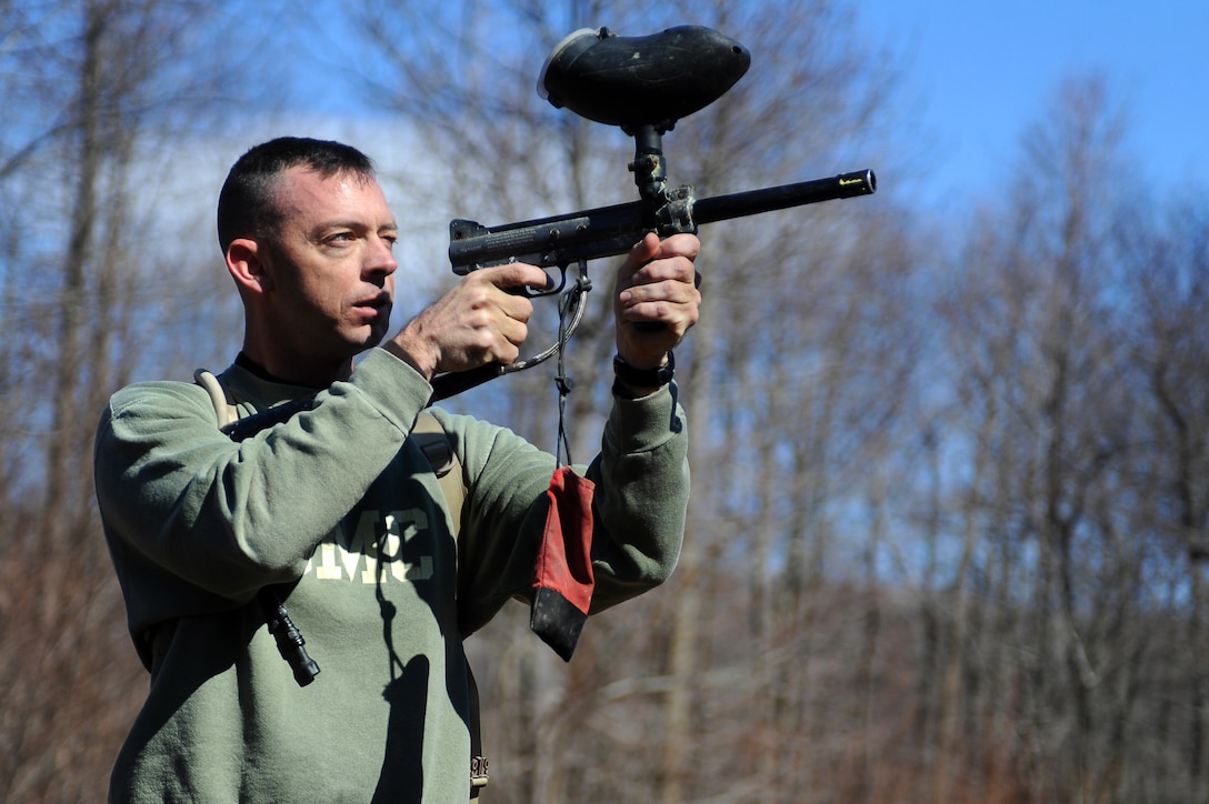 Lt. Col. Jonathan E. Langlois, Marine Corps Institute company commanding officer, shoots at his targets with a paintball gun during Alive, the second event of the 2012 Commander’s Cup, at Deep Creek Lake, Md., Feb. 27. Alive was a race comprising more than seven miles of running through rugged terrain and getting past several obstacles along the way. At the halfway point, the competitors had to shoot five paintballs at targets 25 yards away. (Official Marine Corps Photo by Lance Cpl. Mondo Lescaud/Released)