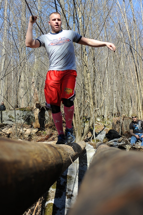 Pfc. Zachary Fischer, Marine Barracks Washington Company B ceremonial marcher, negotiates a creek by balancing across a log during Alive, the second event of the 2012 Commander’s Cup, at Deep Creek Lake, Md., Feb. 27. Alive was a race comprising more than seven miles of running through rugged terrain and getting past several obstacles along the way. Fischer finished in 10th place overall. (Official Marine Corps Photo by Lance Cpl. Mondo Lescaud/Released)::r::::n::