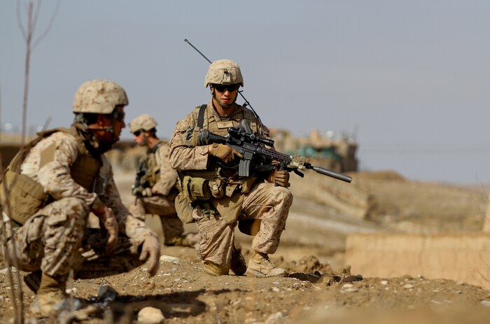 Corporal Randy Cripe, a squad leader with 2nd Platoon, Lima Company, provides security, with the rest of his squad, while on patrol Feb. 27, 2012. Cripe, currently deployed with 3rd Battalion, 7th Marine Regiment, used Lance Cpl. Nicholas Wurst as his go-to-guy, using his ability to adapt, to fill the squads needs. Cripe used Wurst as his coverman and navigator while patrolling today.
