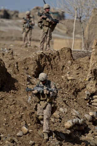 Corporal Randy Cripe, a squad leader with 2nd Platoon, Lima Company, provides security, with the rest of his squad, while on patrol Feb. 27, 2012. Cripe, currently deployed with 3rd Battalion, 7th Marine Regiment, used Lance Cpl. Nicholas Wurst as his go-to-guy, using his ability to adapt, to fill the squads needs. Cripe used Wurst as his coverman and navigator while patrolling today.