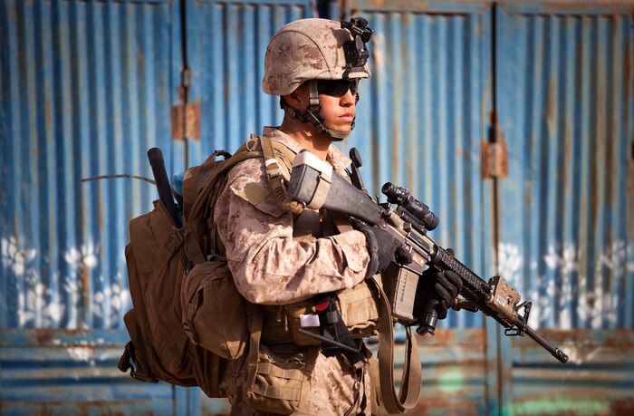 Cpl. Kyle Ferrin, a 21-year-old rifleman with 3rd Platoon, Kilo Company, 3rd Battalion, 3rd Marine Regiment, and native of Clinton, Utah, holds security at an intersection while halted during a security patrol here, Feb. 27. On the patrol, the 3rd Platoon Marines partnered with Afghan National Police to search for insurgent activity in Safar Bazaar, Garmsir district’s busiest commercial center. They mentor the ANP in a partnered combat operations center at PB Bury, and patrol with them throughout Safar. The partnership is a vital part of preparing the Afghan National Security Forces to assume lead security responsibility in Garmsir.