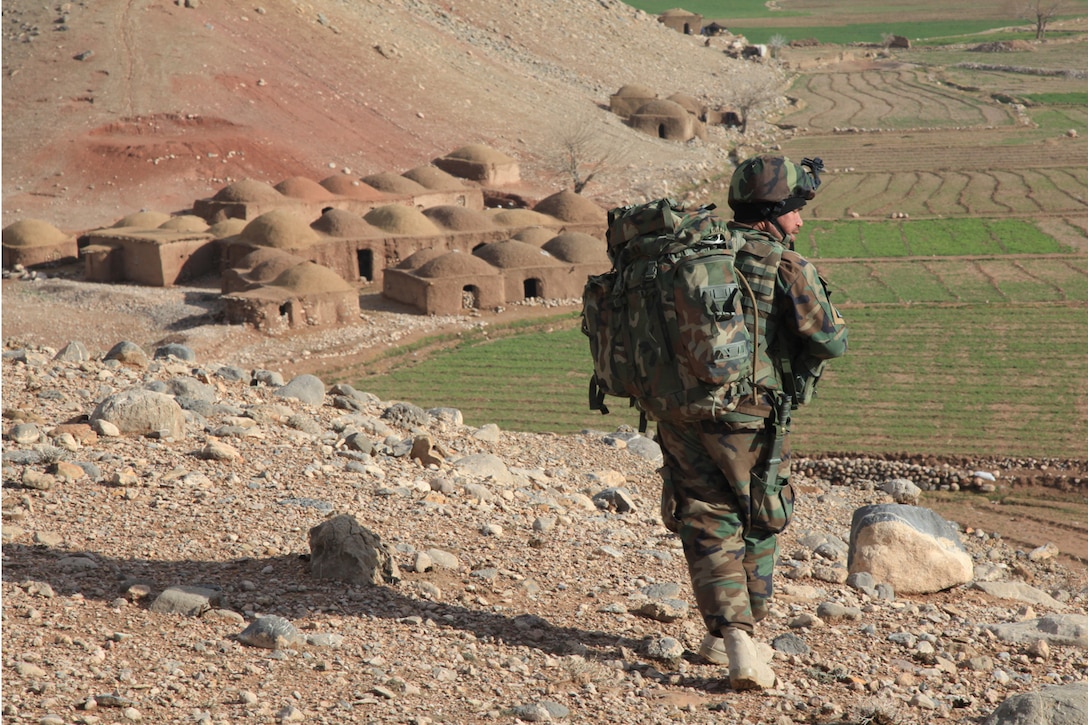 An Afghan Commando with the 9th Kandak conducts a presence patrol. Commandos with the 9th Kandak work to protect local communities and eradicate insurgent activity in the region. (U.S. Marine Corps photo by Cpl. Kyle McNally)