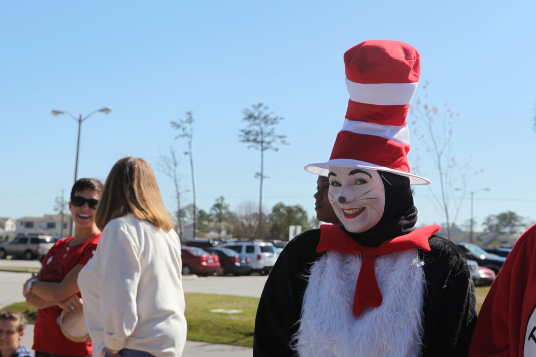 Ashley Briely, a parent and frequent volunteer at Tarawa Terrace II Elementary school, smiles while wearing a Dr. Seuss' "Cat in the Hat" costume during the school's  annual character parade. The parade was held to celebrate Read Across America, a nationwide event that aims to get children excited about reading.